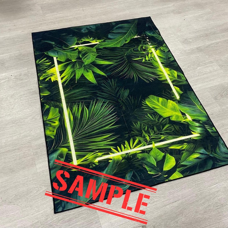 May include: Rectangular rug featuring a vibrant tropical leaf pattern in shades of green and black. A neon yellow geometric frame outlines the design. The word "SAMPLE" is printed across the bottom in red.