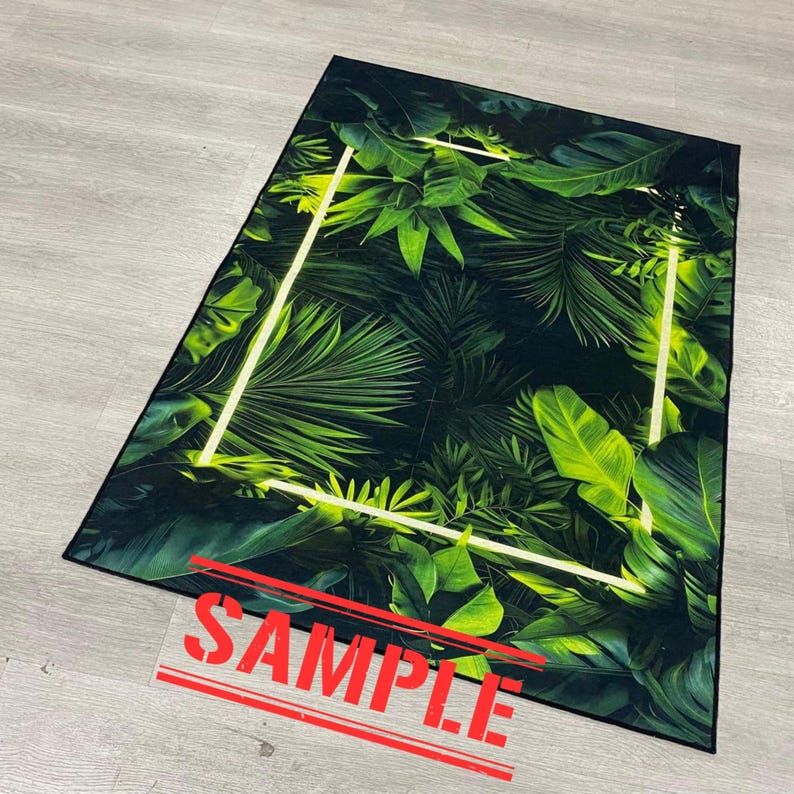 May include: Rectangular rug featuring a vibrant green tropical leaf pattern with a white rectangular border. The rug's design includes various shades of green, creating a lush, natural aesthetic. The word "SAMPLE" is printed across the bottom.