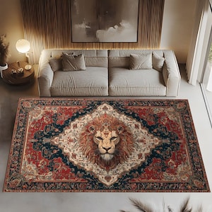 May include: A rectangular area rug with a detailed lion's face in the center. The rug features a red and navy blue border with an ornate floral design. The lion's mane is a warm orange color.