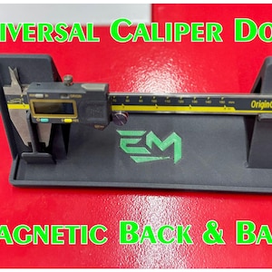 May include: A black universal caliper dock with a digital caliper. The dock has a magnetic back and base. The caliper is black and yellow with the text "OriginCal" and "US Patent". The text "Universal Caliper Dock" and "Magnetic Back & Base" are in green.