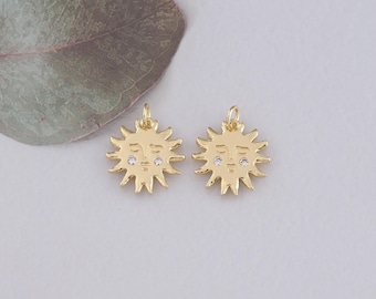 May include: Two gold sun charms with a face and small clear rhinestones for eyes.