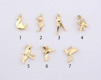 May include: A collection of seven gold-colored origami-style charms in various bird and animal shapes. The charms include a swan, seahorse, bird, flamingo, and hummingbird. Each charm is numbered for easy identification.