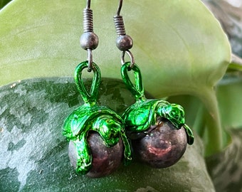 Turtle Dangly Earrings - fun retro 1990s grunge y2k style, green and silver tone metal, turtles grasping a gunmetal pearly planet like bead