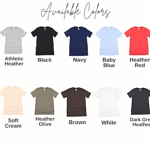 May include: A color chart displaying ten short-sleeved t-shirts in various shades including athletic heather, black, navy, baby blue, heather red, soft cream, heather olive, brown, white, and dark grey heather, with the text Available Colors.