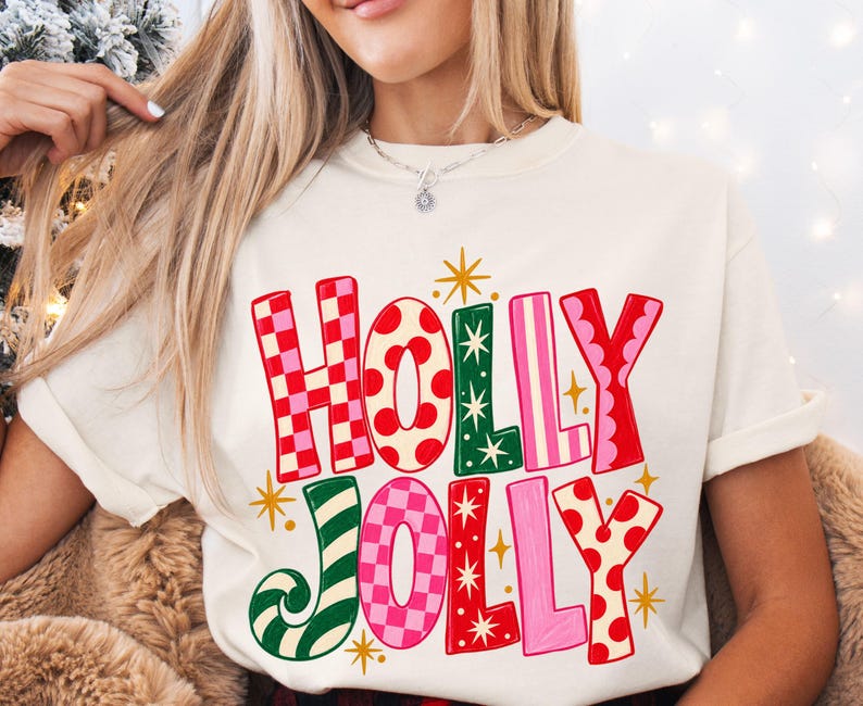 Holly Jolly Christmas shirt with oversized hand-drawn red, pink, green and cream lettering featuring checkerboard, polka dot and striped patterns with retro gold starbursts, shown on adult Comfort Colors tees and Gildan sweatshirts.