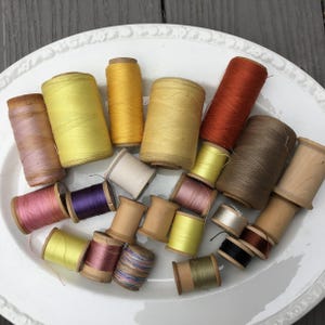 23 Vintage wooden thread spools large and small
