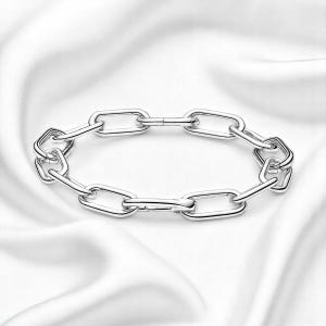 May include: A silver chain bracelet with a link design. The bracelet is made of polished metal and has a secure clasp.