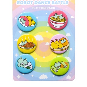 May include: A set of six colorful button pins featuring cute frog characters enjoying different Japanese foods. The buttons are labeled "Robot Dance Battle" and "Button Pack".