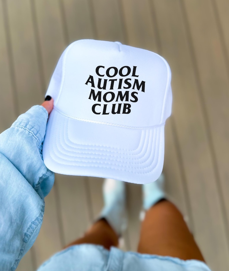 May include: White trucker hat with black text that reads "COOL AUTISM MOMS CLUB".