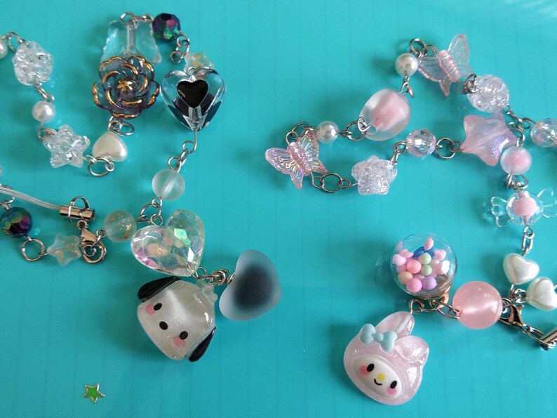 May include: A colorful charm bracelet with a variety of charms, including hearts, stars, butterflies, and a small dog. The bracelet is made of silver chain and has a clear glass bead with colorful sprinkles inside.