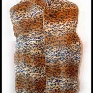May include: A brown, tan, and black leopard print fleece scarf. The scarf is folded in half and is displayed on a mannequin.