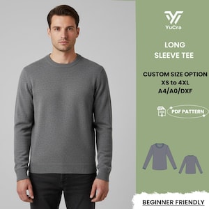 May include: A gray long-sleeve tee shirt. The image includes the text "YuCra LONG SLEEVE TEE CUSTOM SIZE OPTION XS to 4XL A4/A0/DXF PDF PATTERN BEGINNER FRIENDLY". The shirt is shown on a person.