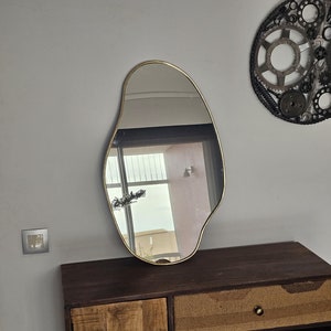 Moroccan handmade brass wall mirror in irregular shape