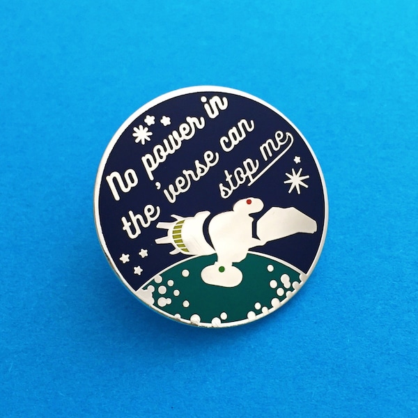 May include: A round, blue and white enamel pin with a spaceship flying over a planet. The text on the pin reads "No power in the 'verse can stop me".