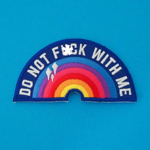 May include: A blue and white embroidered patch with a rainbow and the text "DO NOT F*CK WITH ME".