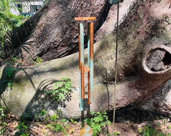 Wind Chime #51 Five one  inch diameter oxidized and flame treated copper pipes with sheet brass wind paddle. Teakwood top, center.