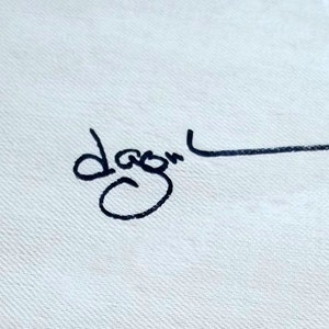 May include: Black and white signature with the name "Dagon" written in cursive.