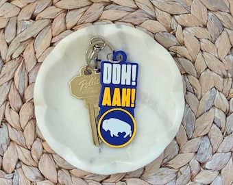 Llavero o etiqueta para bolso Buffalo Hockey Ooh Ahh azul y amarillo