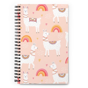 May include: A pink spiral bound notebook with a pattern of white llamas and rainbows. The llamas are wearing colorful decorations and the rainbows are in shades of pink, orange, and yellow.