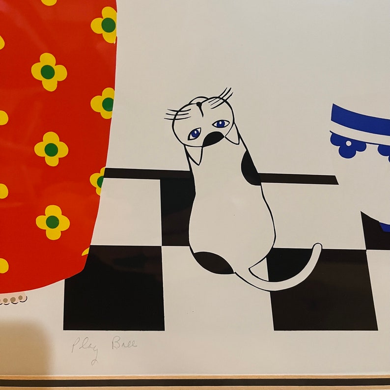 May include: A black and white illustration of a cat with blue eyes on a white background with a black and white checkered pattern. The cat is looking down and has a sad expression. The text "Play Ball" is written in black ink at the bottom of the image.