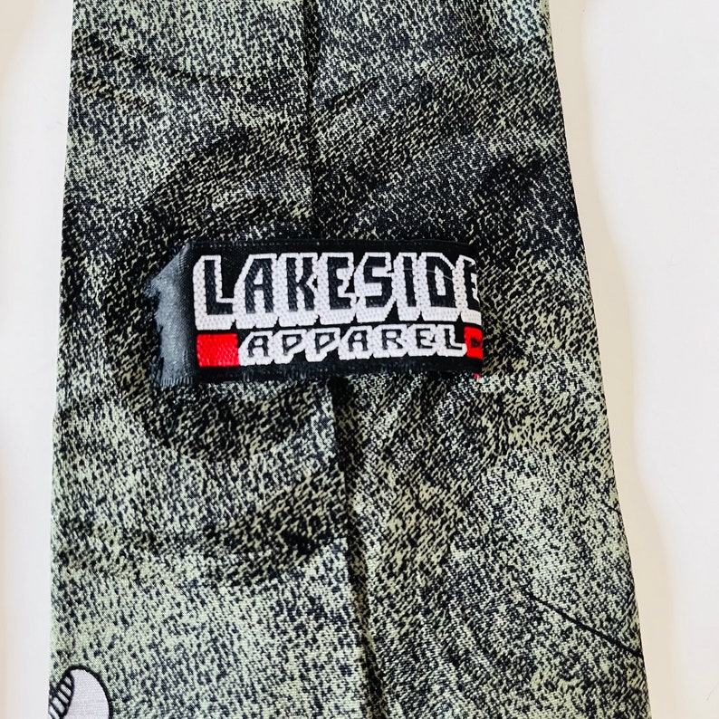 May include: A green and black tie with a white "Lakeside Apparel" label.