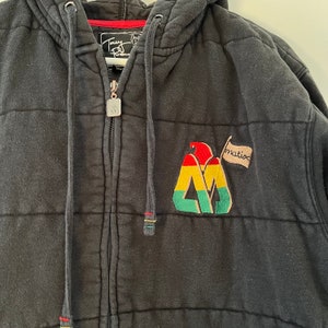 May include: Black quilted zip-up hoodie with a red, yellow, and green logo and the word "Matix" on a white flag.