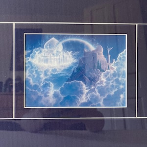 May include: A framed print depicts a fantasy landscape with a castle on a rocky peak and a floating palace, both bathed in ethereal light. A rainbow arches across the sky, and fluffy clouds fill the scene, creating a dreamlike atmosphere.