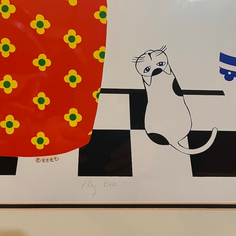 May include: A black and white illustration of a cat with blue eyes, sitting on a black and white checkered floor. The cat is looking to the left. The background is a red skirt with yellow flowers. The image is signed "Play Rue".