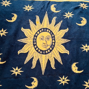 May include: A set of three ceramic mugs with a speckled, cream-colored glaze. Each mug features a different hand-painted floral design in shades of blue, green, and yellow. The mugs have a simple, rounded shape and a comfortable handle.