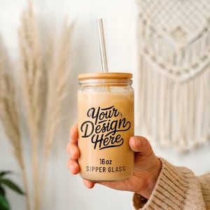 May include: A 16 oz. clear glass sipper with a bamboo lid and a straw. The glass has a black design that says "Your Design Here".