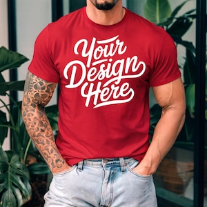 K&ouml;nnte beinhalten: Ein rotes T-Shirt mit dem Text "Your Design Here" in wei&szlig;en Buchstaben.