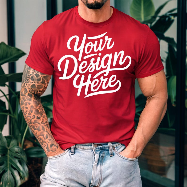 K&ouml;nnte beinhalten: Ein rotes T-Shirt mit dem Text "Your Design Here" in wei&szlig;en Buchstaben.