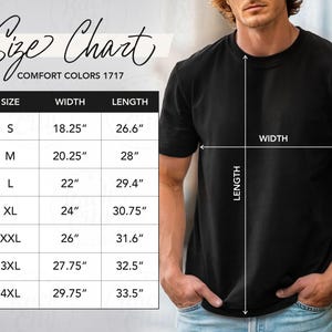 May include: Black t-shirt with a size chart. The chart shows measurements for sizes S to 4XL, with widths ranging from 18.25 inches to 29.75 inches and lengths from 26.6 inches to 33.5 inches. The shirt is labeled "Comfort Colors 1717".