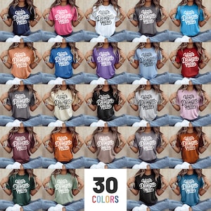 May include: A selection of 30 t-shirts in various colours, each with the text "Your Design Here" in a script font. The shirts are modelled on a person wearing blue jeans. The image also includes the text "30 COLORS".