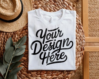 May include: White t-shirt with the text "Your Design Here" printed in black on a woven straw background.