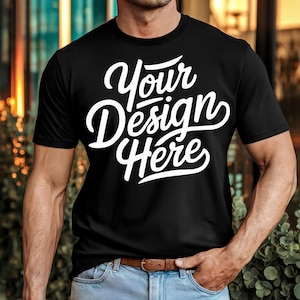 Op de afbeelding: Een zwart T-shirt met de tekst "Your Design Here" in witte letters.