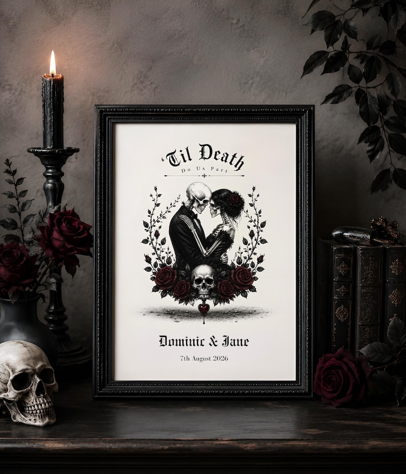 May include: A framed print featuring a skeleton couple in formal attire embracing, surrounded by a wreath of dark red roses and a skull. The text reads Til Death Do Us Part, Dominic & Jane, and 7th August 2026 in a gothic font style.