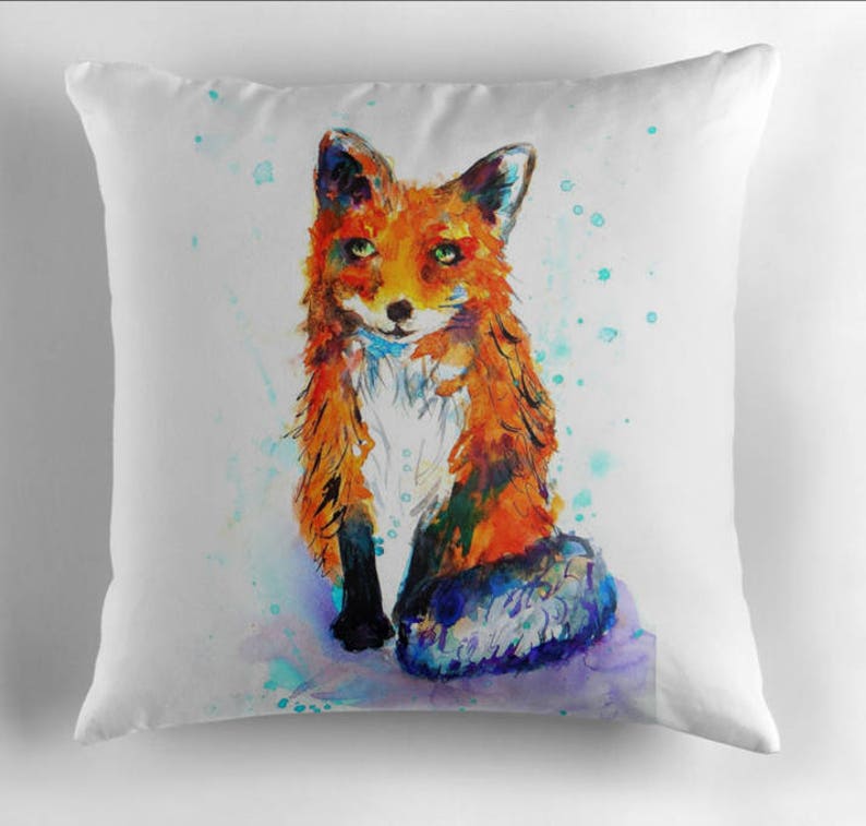 May include: A watercolor painting of a red fox with green eyes sitting on a white background with blue and green watercolor splatters.