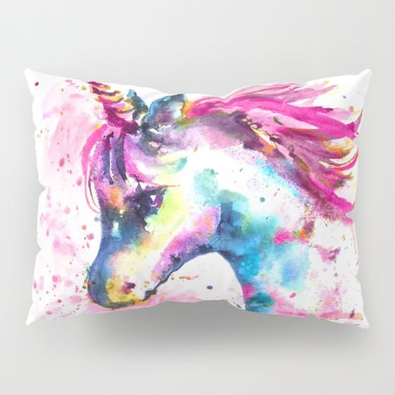 May include: A watercolor painting of a unicorn's head with pink, blue, and purple hues on a white background.