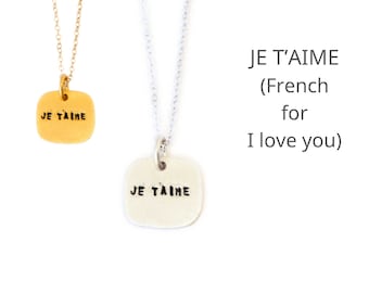 Quote Je T'Aime necklace, French for "I love you".  Handcrafted by Chocolate & Steel, handstamped necklace recycled silver and gold vermeil