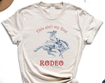 Camiseta "Esta no es mi primera rodeo", camiseta de vaquera, camiseta de amante de los caballos, camiseta retro campestre, camiseta de vida campestre, camiseta del salvaje oeste, camiseta de reina del rodeo