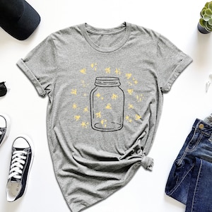 a t - shirt with a jar of stars on it