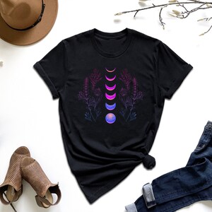a t - shirt with a design of a flower and a moon