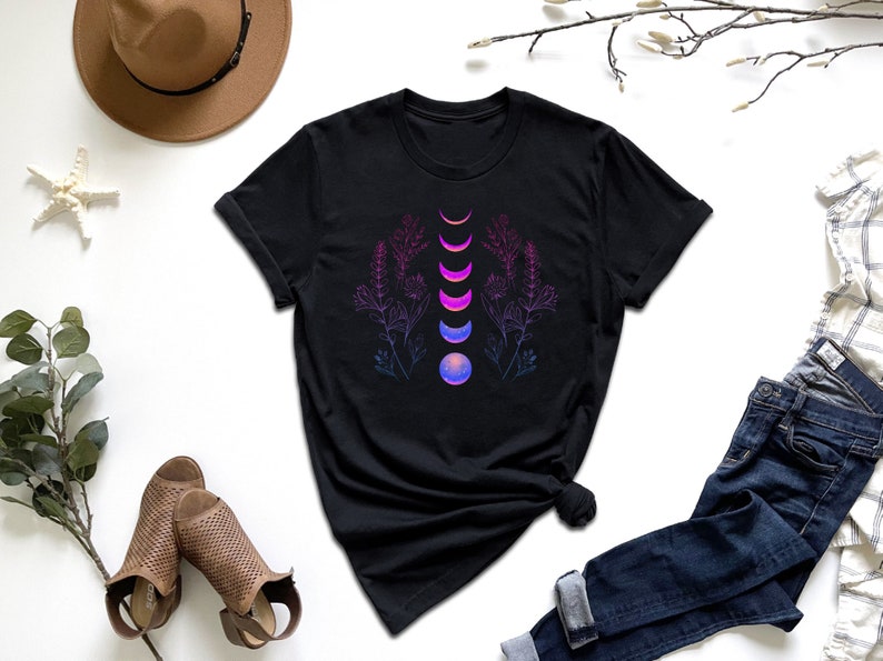 a t - shirt with a design of a flower and a moon