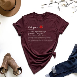 a t - shirt with a poem on it next to a hat and a pair