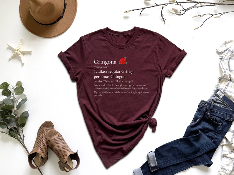 a t - shirt with a poem on it next to a hat and a pair