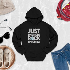 a black hoodie that says just one more rock i promise