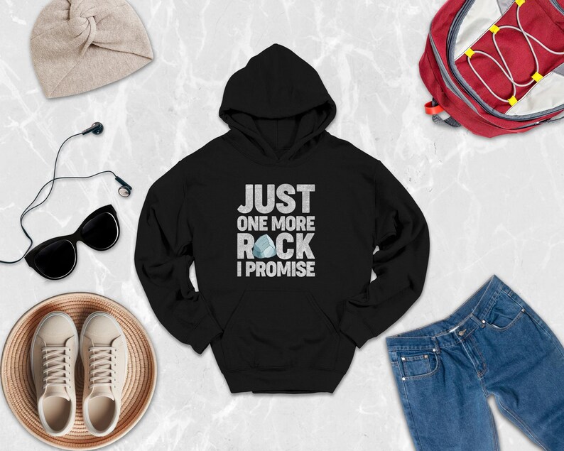 a black hoodie that says just one more rock i promise