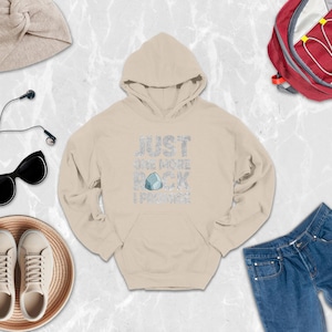 a white hoodie, jeans, a pair of sneakers, a backpack, and