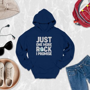 a blue hoodie that says just one more rock i promise